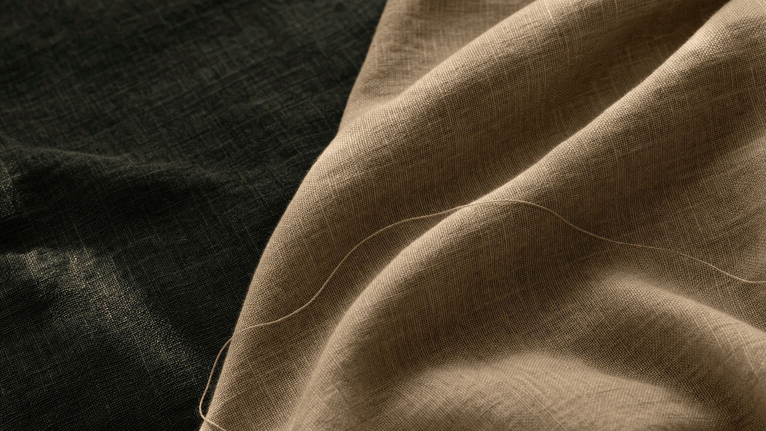 Sand-taupe linen with a fine peach silk thread on charcoal-green linen — calm atmospheric texture