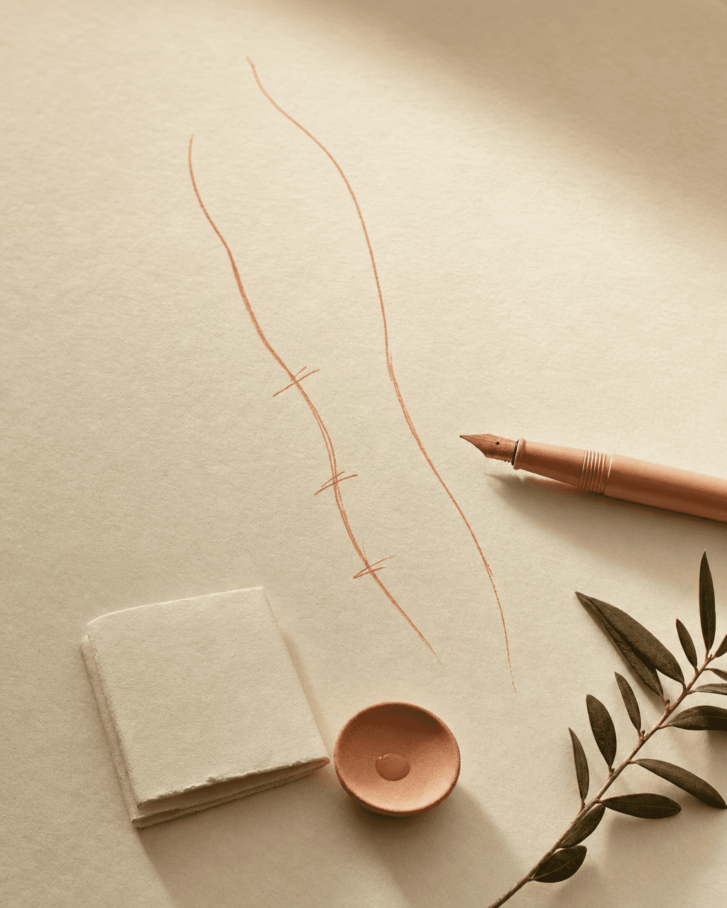 Bone-cream paper with a hand-drawn peach ink line of a thigh contour study, a peach fountain pen beside it — still life of an individual marking