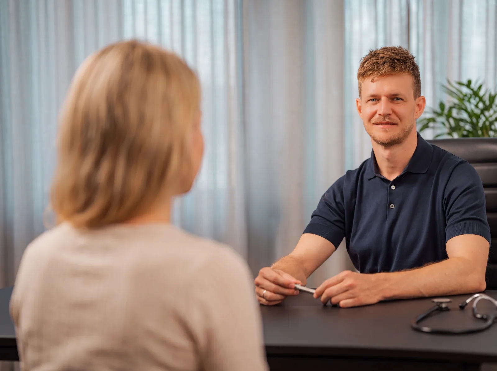 Ärztliches Aufklärungsgespräch — Arzt erläutert einer Patientin die Behandlung, Praxis Ästhetik am Isartor München